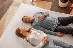 woman and man laying on tempurpedic mattress topper